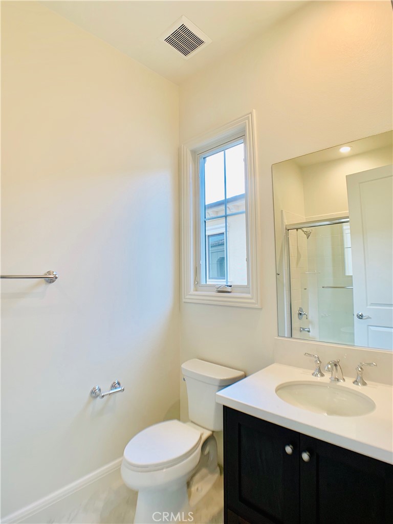 152 Leafy Pass Irvine, CA 92602 - Photo 37 of 55 a bathroom with a granite countertop sink a toilet and a mirror
