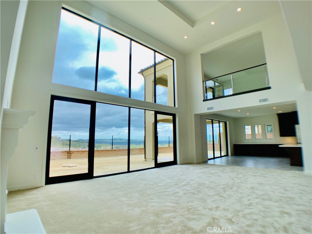 152 Leafy Pass Irvine, CA 92602 - Photo 5 of 55 an empty room with large windows