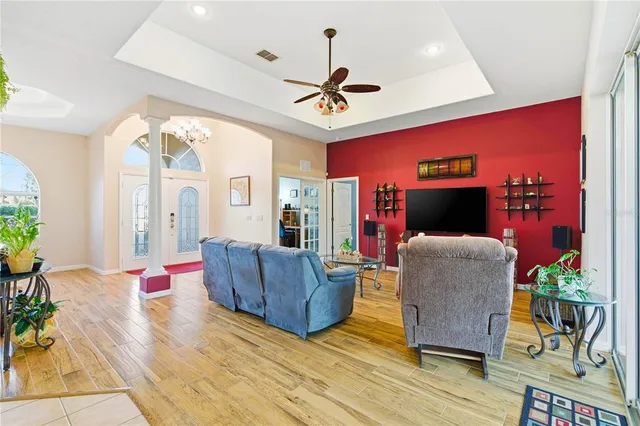a spacious bathroom with a double vanity sink a large mirror a bathtub and next to a window