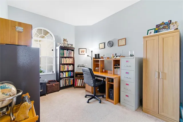 a kitchen with stainless steel appliances kitchen island granite countertop a dining table chairs sink and cabinets