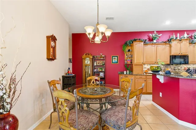 a view of a patio with a table and chairs under an umbrella