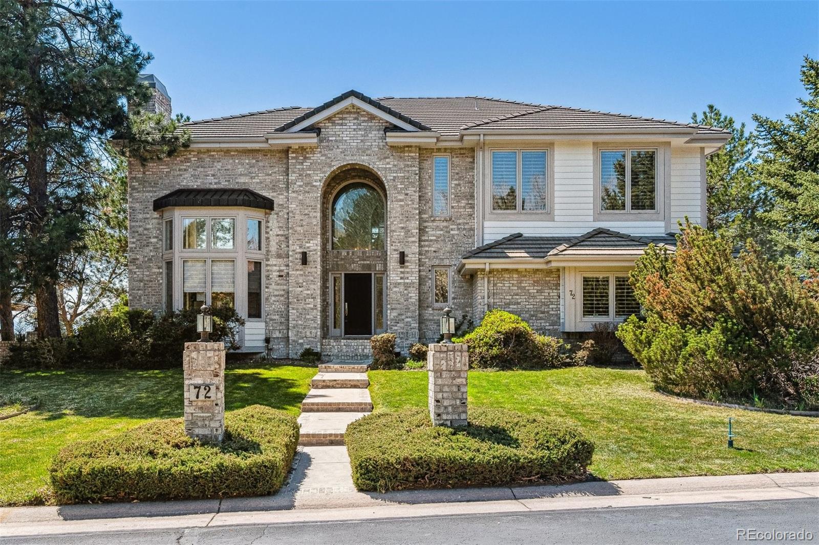 72 Falcon Hills Drive Highlands Ranch, CO 80126 - Photo 1 of 49 a front view of a house with garden