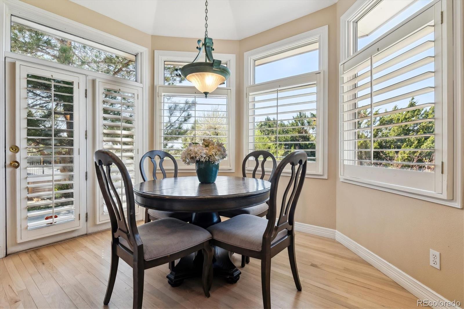 72 Falcon Hills Drive Highlands Ranch, CO 80126 - Photo 18 of 49 a view of a dining room with furniture window and wooden floor