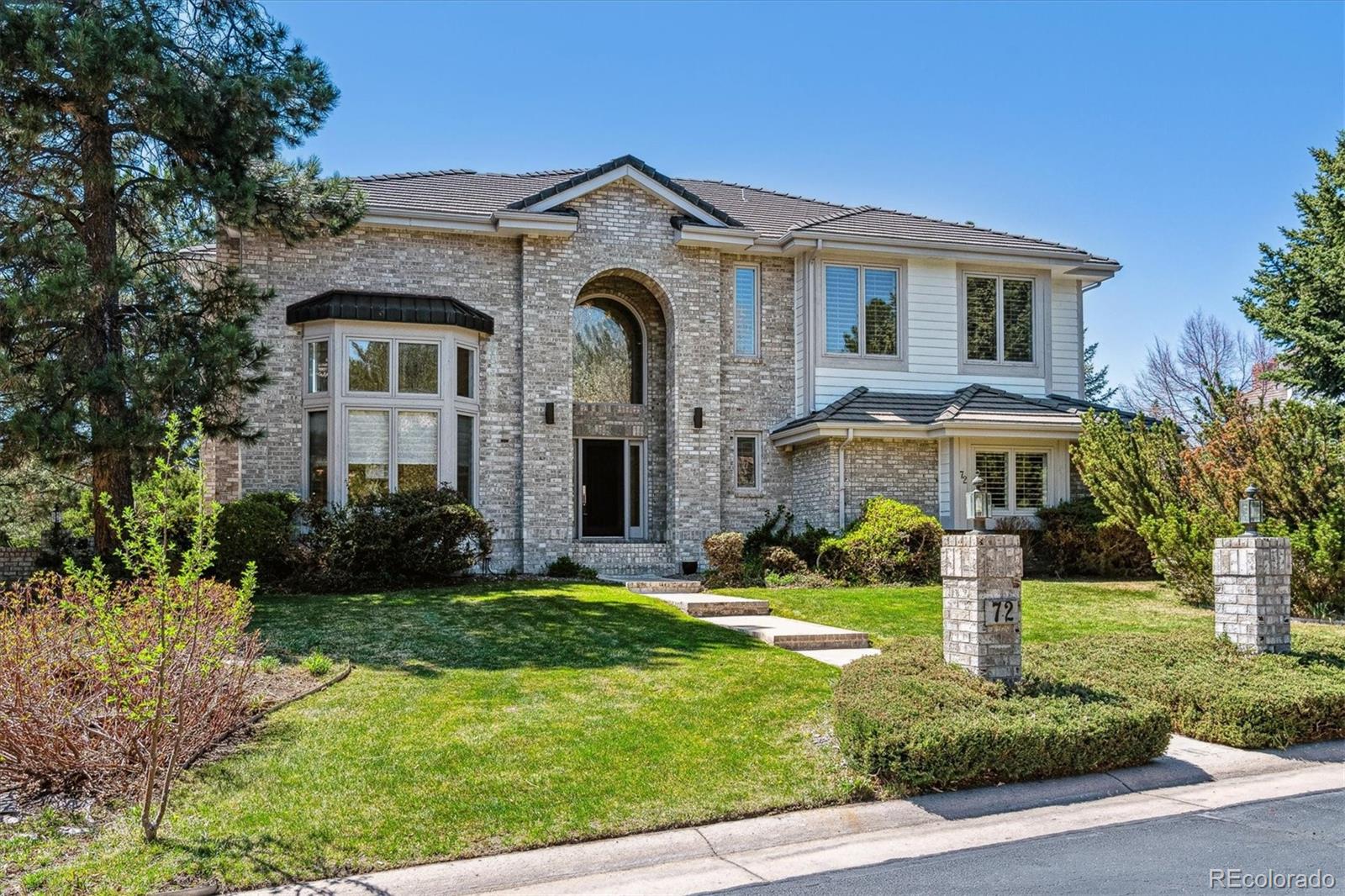 72 Falcon Hills Drive Highlands Ranch, CO 80126 - Photo 3 of 49 a front view of a house with a yard