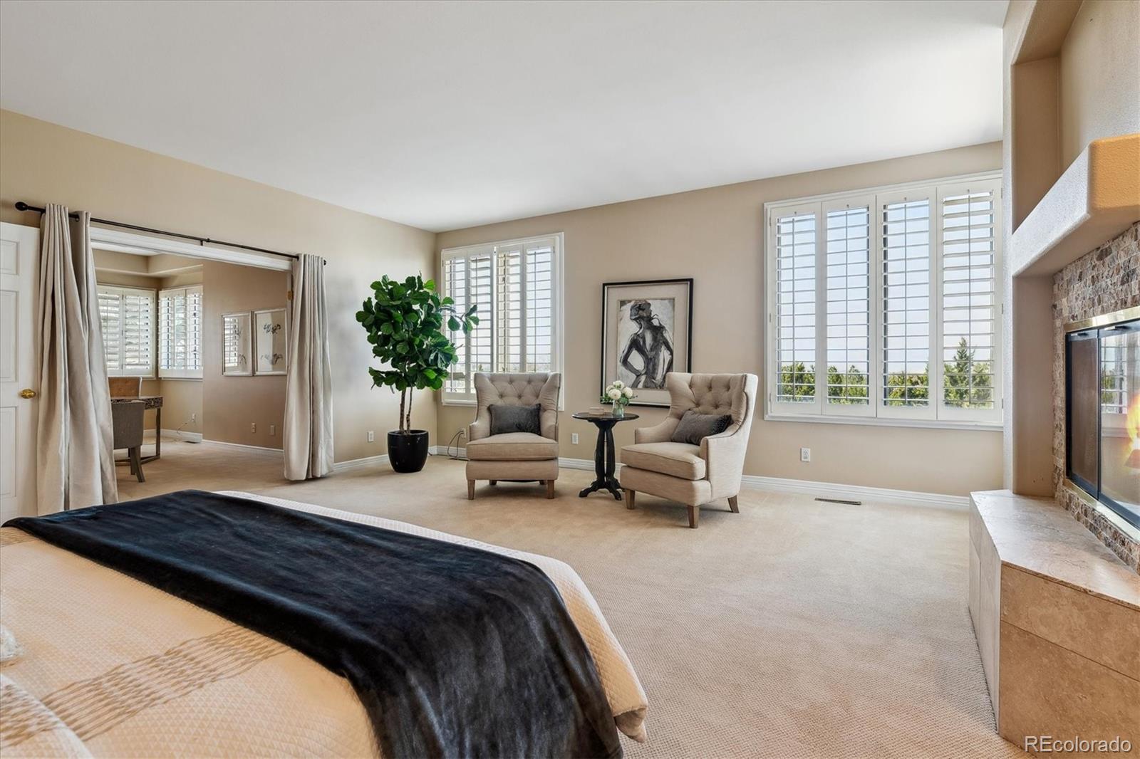 72 Falcon Hills Drive Highlands Ranch, CO 80126 - Photo 33 of 49 a spacious bedroom with a bed and a flat screen television