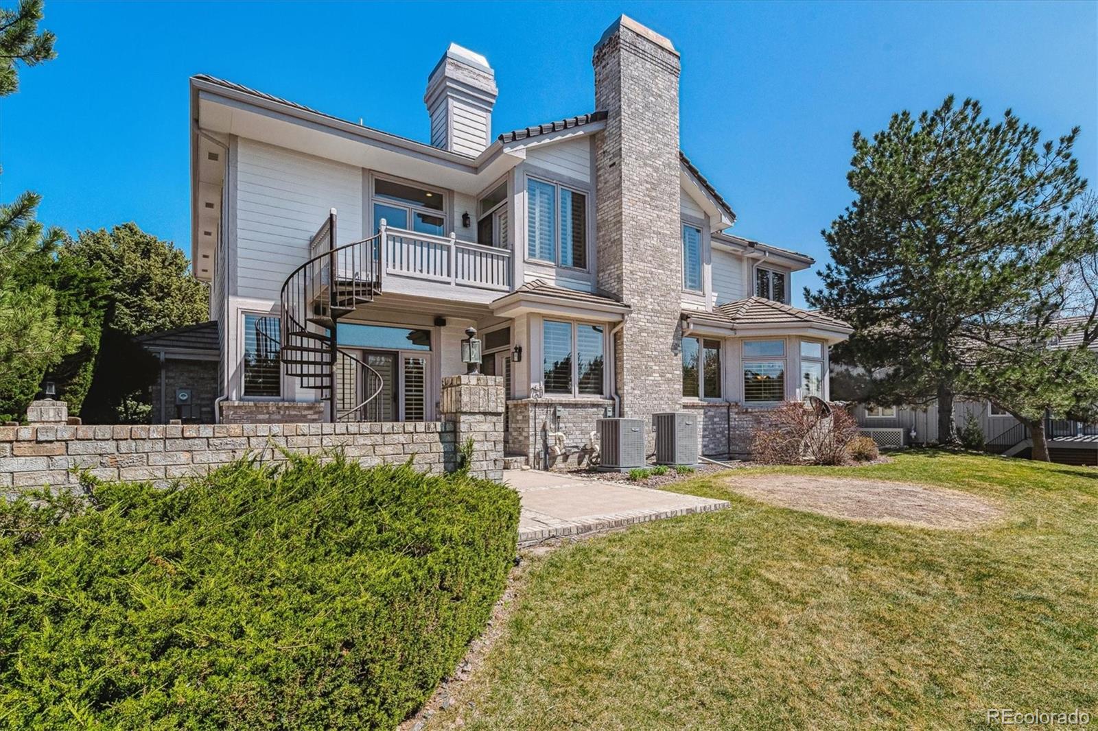 72 Falcon Hills Drive Highlands Ranch, CO 80126 - Photo 44 of 49 a front view of a house with a yard table and chairs
