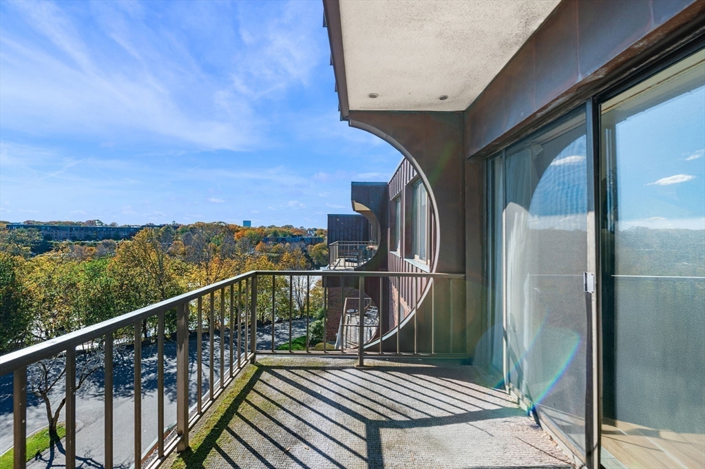 1004 Paradise Road, Unit PHJ Swampscott, MA 01907 - Photo 11 of 29 a view of a balcony with wooden floor and fence