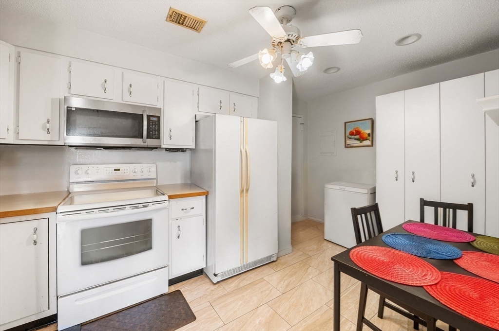 1004 Paradise Road, Unit PHJ Swampscott, MA 01907 - Photo 15 of 29 a kitchen with stainless steel appliances a stove microwave and refrigerator