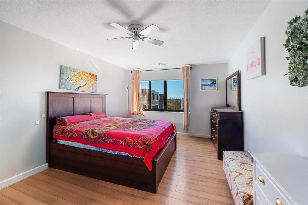 1004 Paradise Road, Unit PHJ Swampscott, MA 01907 - Photo 16 of 29 a bedroom with a bed and wooden floor