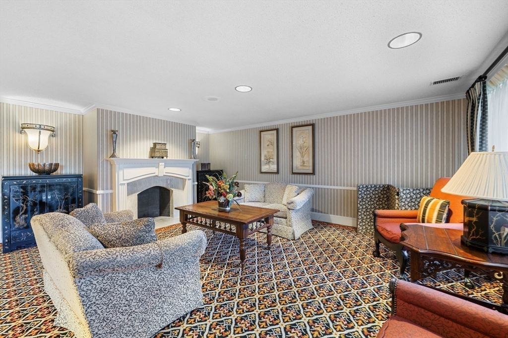 1004 Paradise Road, Unit PHJ Swampscott, MA 01907 - Photo 4 of 29 a living room with furniture a rug and a fireplace