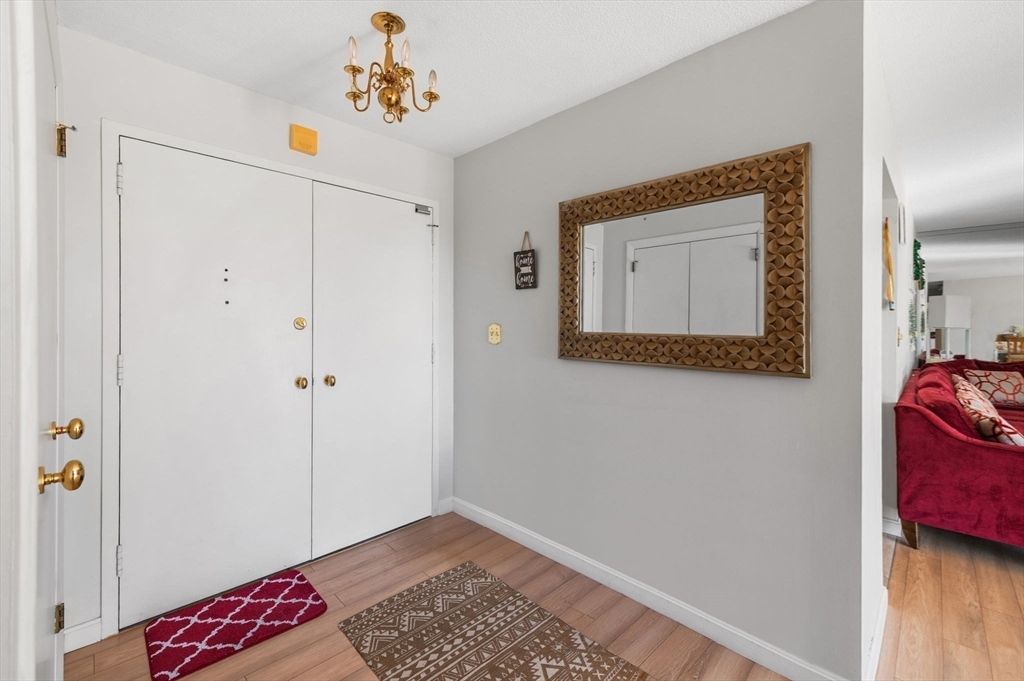 1004 Paradise Road, Unit PHJ Swampscott, MA 01907 - Photo 6 of 29 a hallway with front door wooden floor and closet