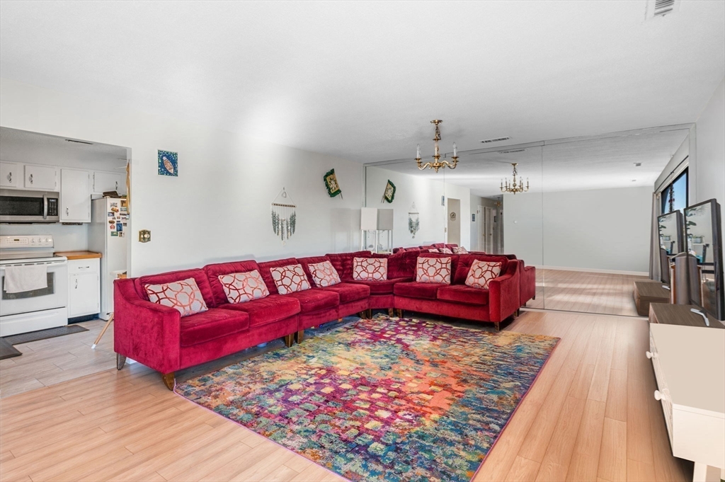 1004 Paradise Road, Unit PHJ Swampscott, MA 01907 - Photo 8 of 29 a living room with furniture and a wooden floor