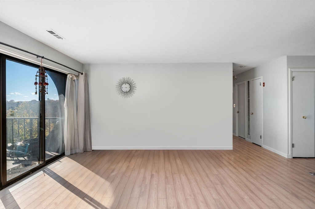 1004 Paradise Road, Unit PHJ Swampscott, MA 01907 - Photo 9 of 29 an empty room with wooden floor and windows