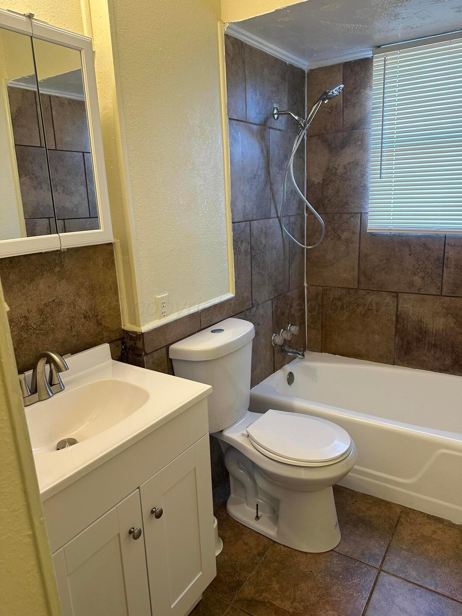 1012 Harper Street Amarillo, TX 79107 - Photo 14 of 22 a bathroom with a sink toilet and shower