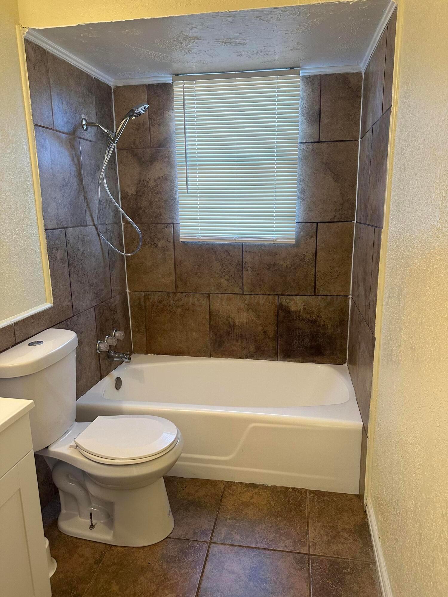 1012 Harper Street Amarillo, TX 79107 - Photo 15 of 22 a bathroom with a toilet and a shower
