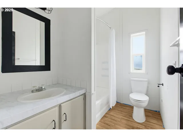 a bathroom with a sink toilet and a mirror