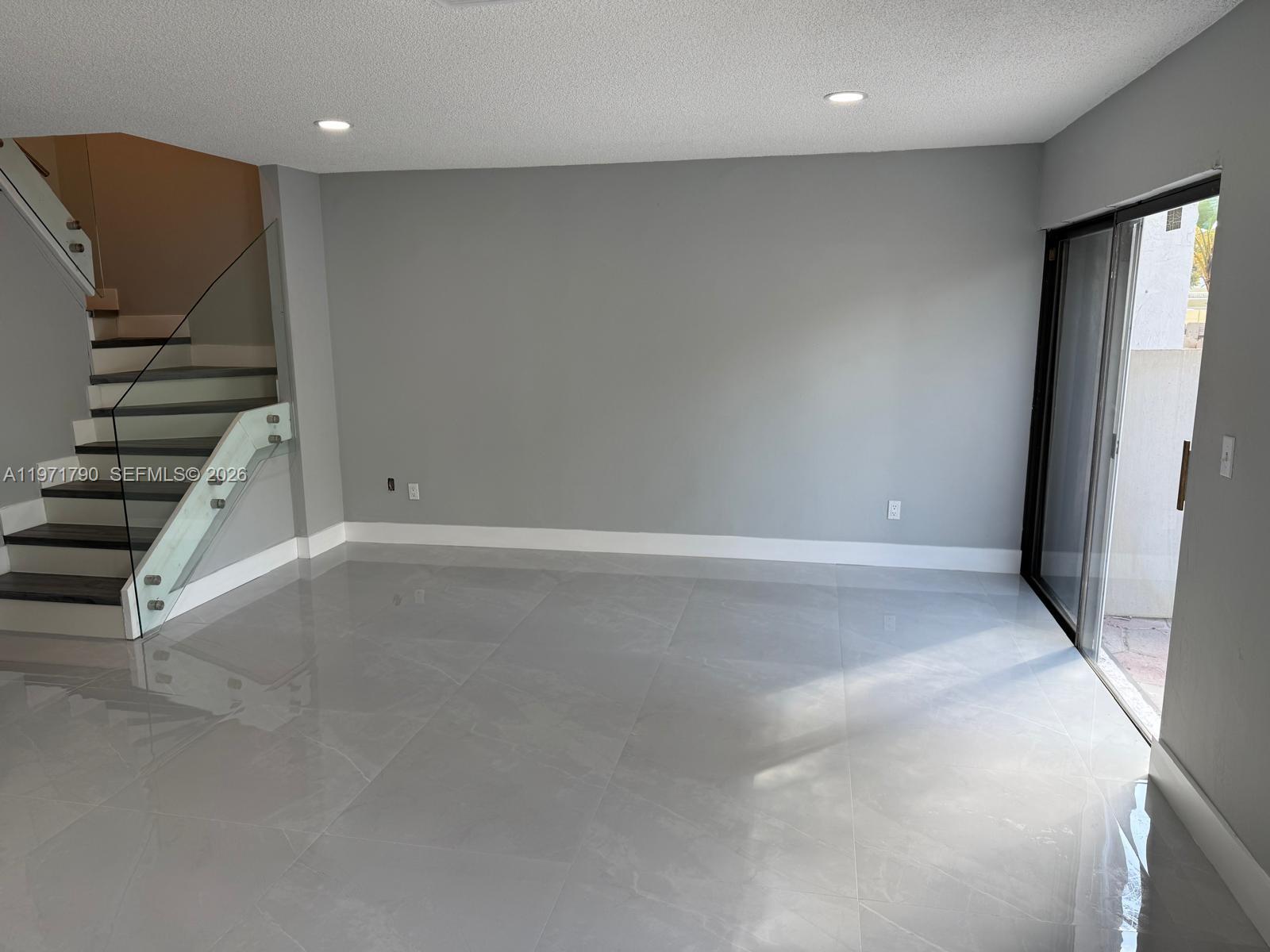2700 North 34th Avenue, Unit I Hollywood, FL 33021 - Photo 11 of 35 an empty room with wooden floor and windows