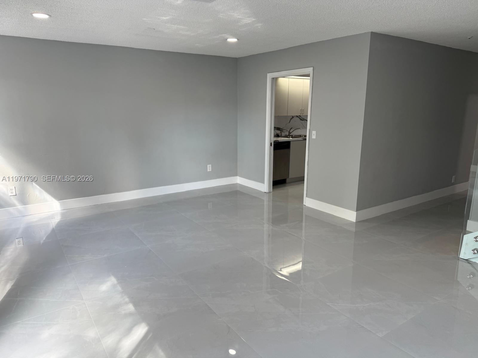 2700 North 34th Avenue, Unit I Hollywood, FL 33021 - Photo 13 of 35 a view of an empty room with kitchen and a window