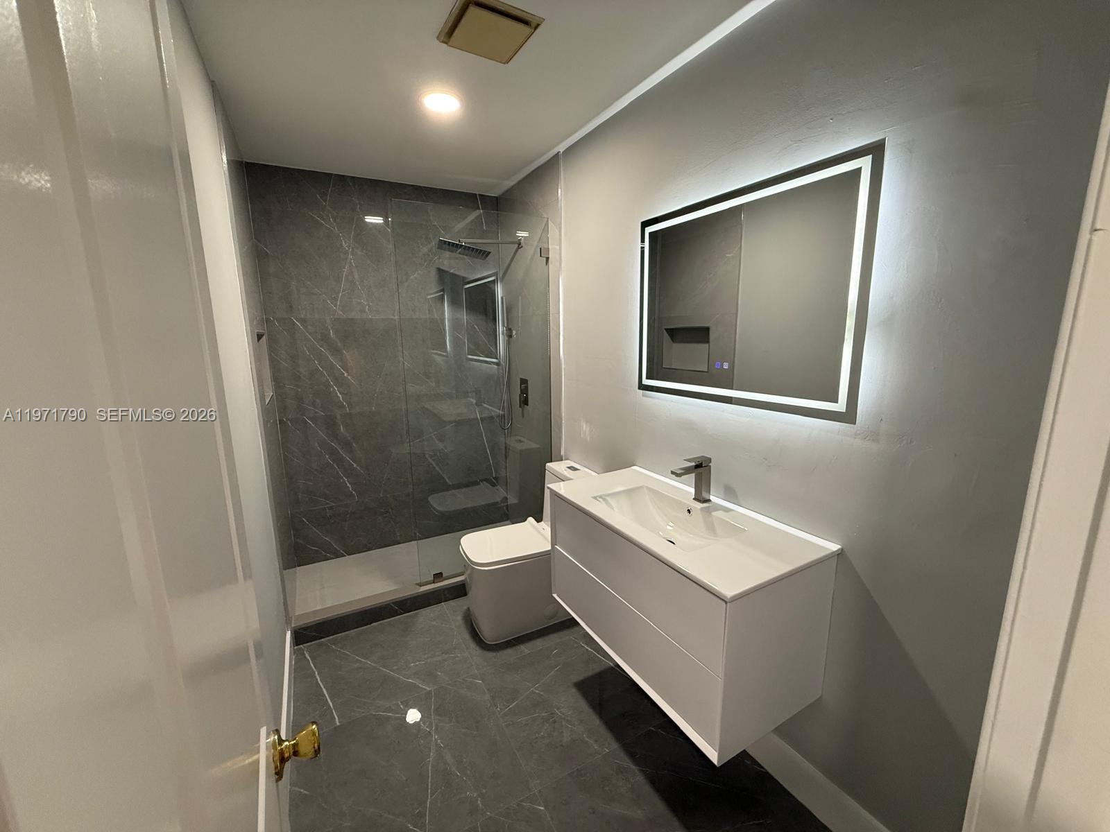 2700 North 34th Avenue, Unit I Hollywood, FL 33021 - Photo 16 of 35 a bathroom with a sink toilet and shower