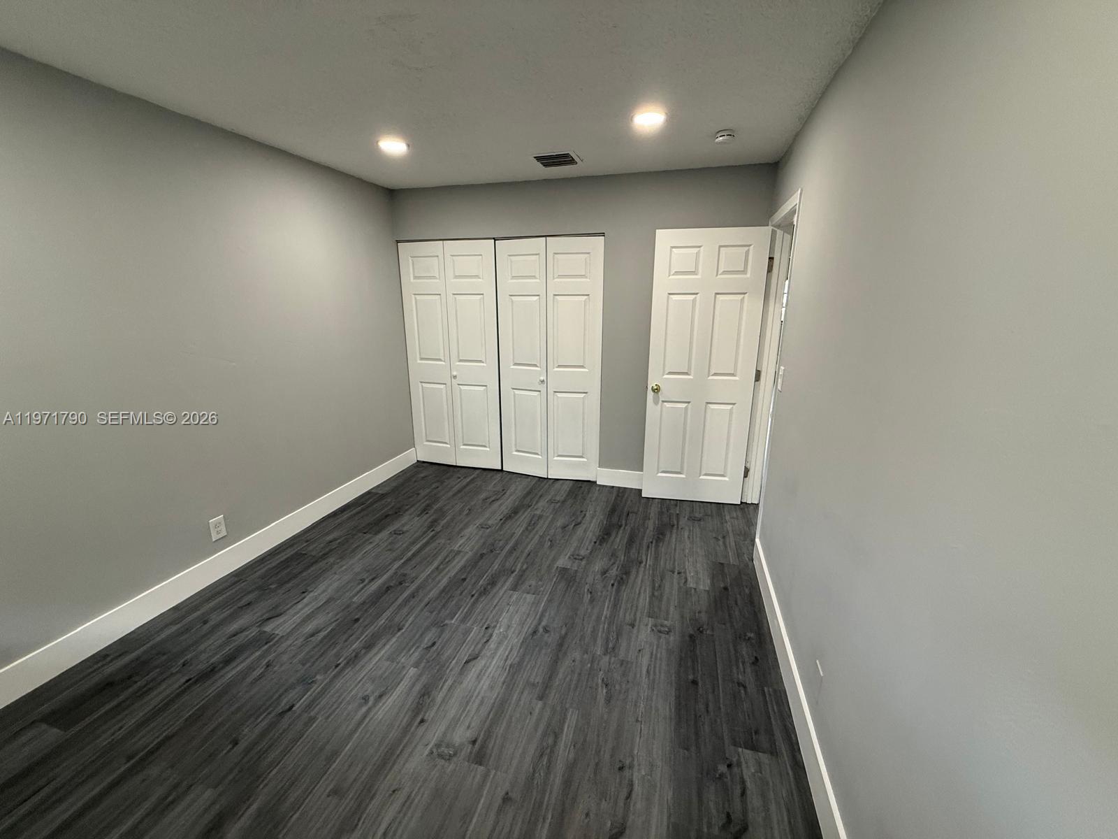 2700 North 34th Avenue, Unit I Hollywood, FL 33021 - Photo 18 of 35 an empty room with wooden floor and windows