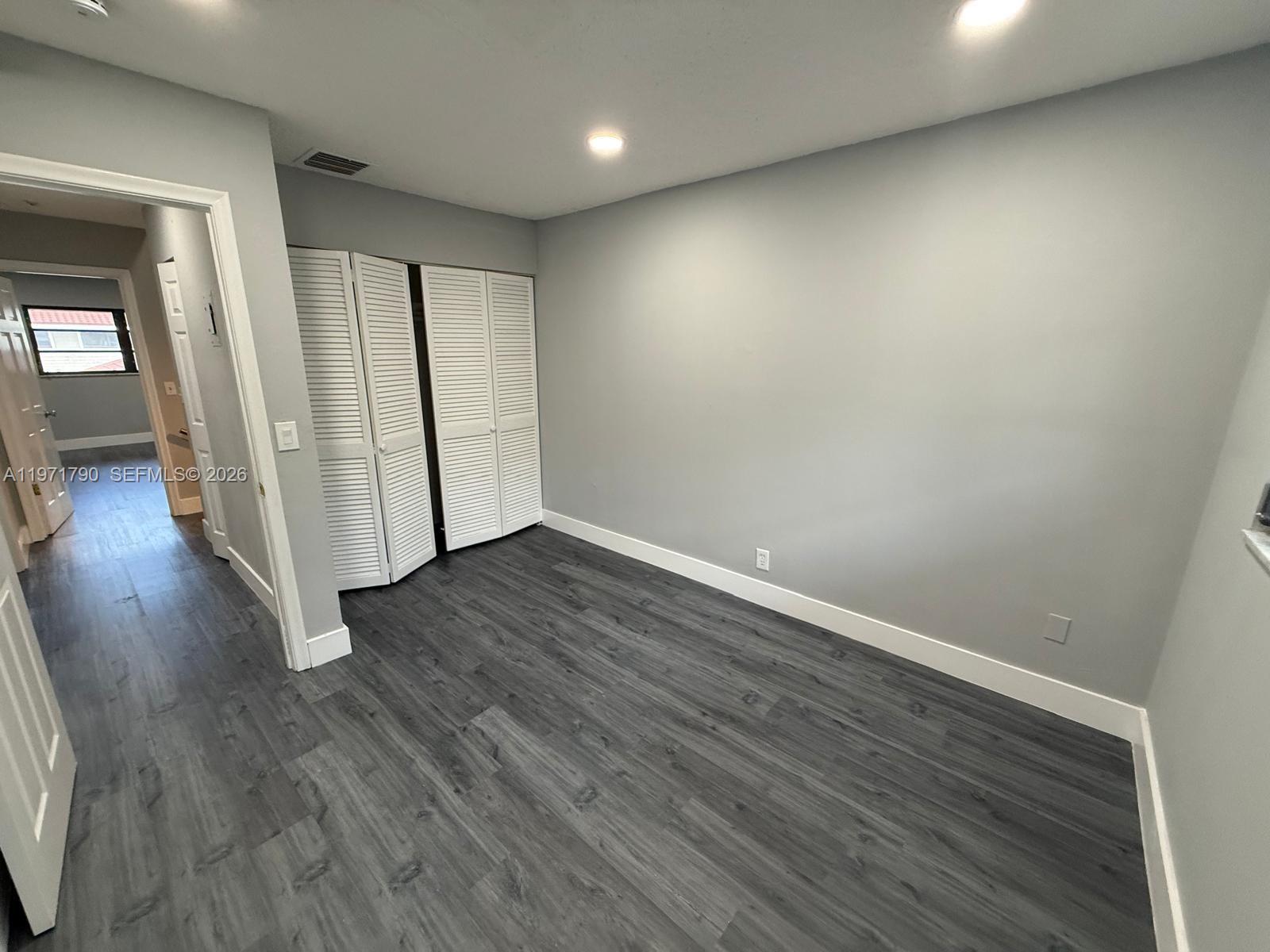 2700 North 34th Avenue, Unit I Hollywood, FL 33021 - Photo 20 of 35 an empty room with wooden floor and windows