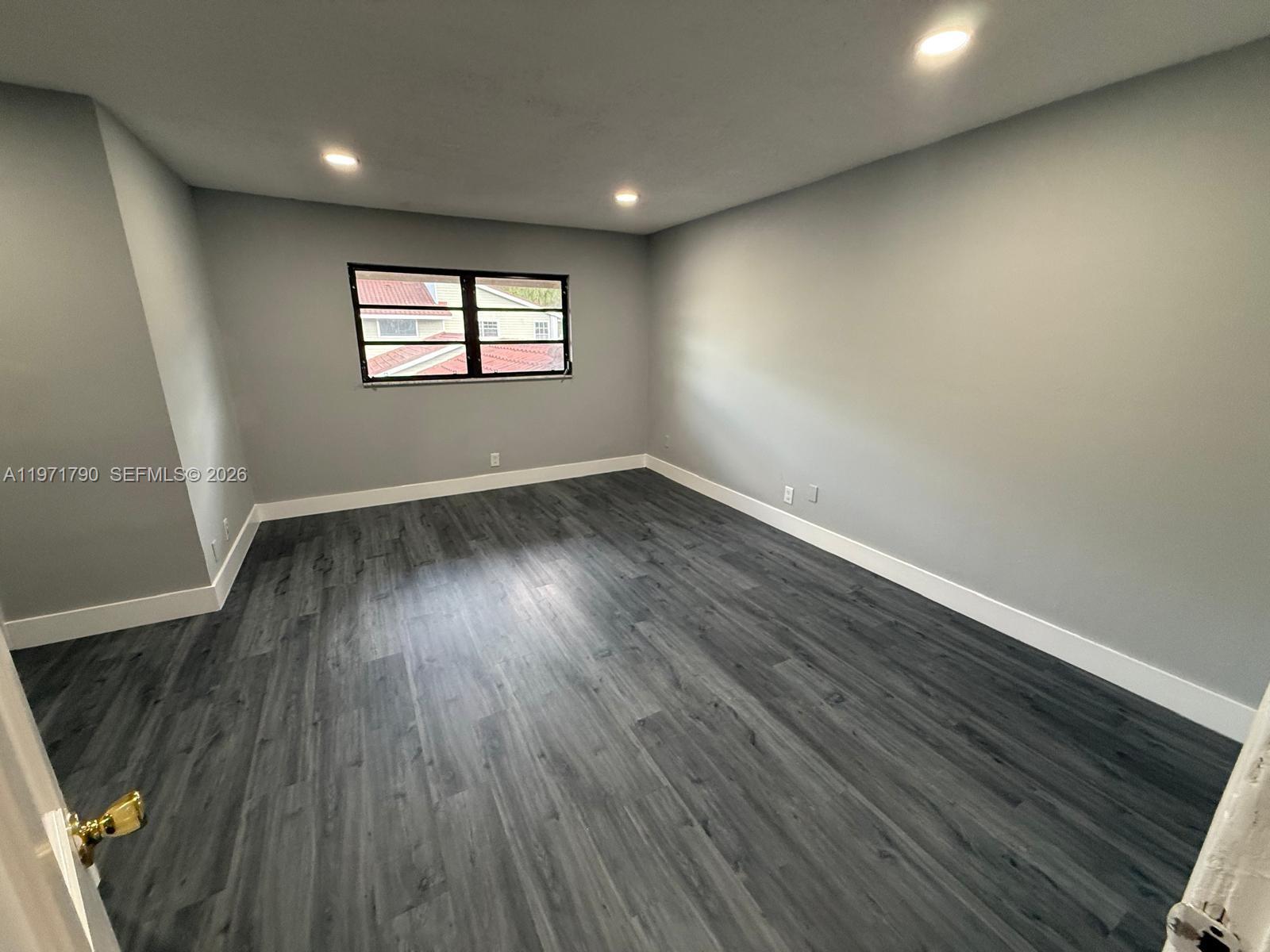 2700 North 34th Avenue, Unit I Hollywood, FL 33021 - Photo 21 of 35 an empty room with wooden floor and windows