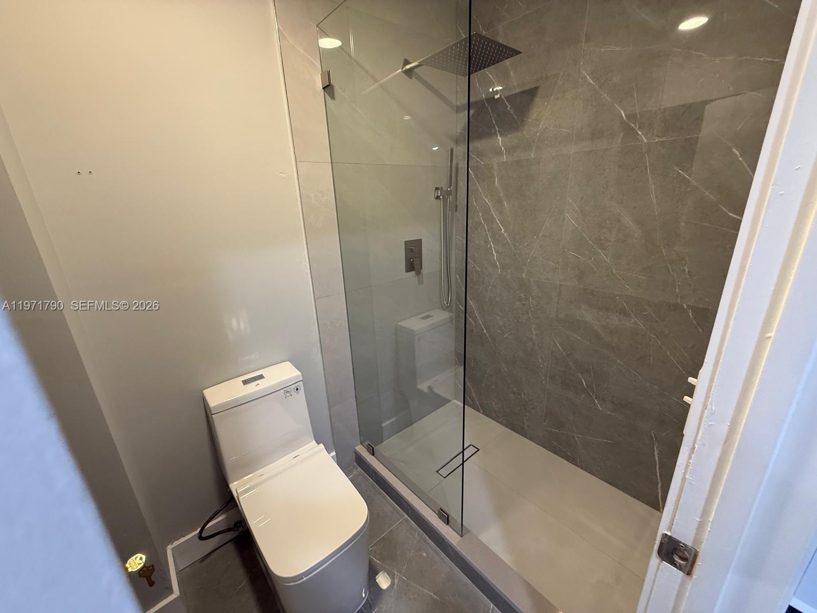 2700 North 34th Avenue, Unit I Hollywood, FL 33021 - Photo 24 of 35 a bathroom with a toilet and a shower