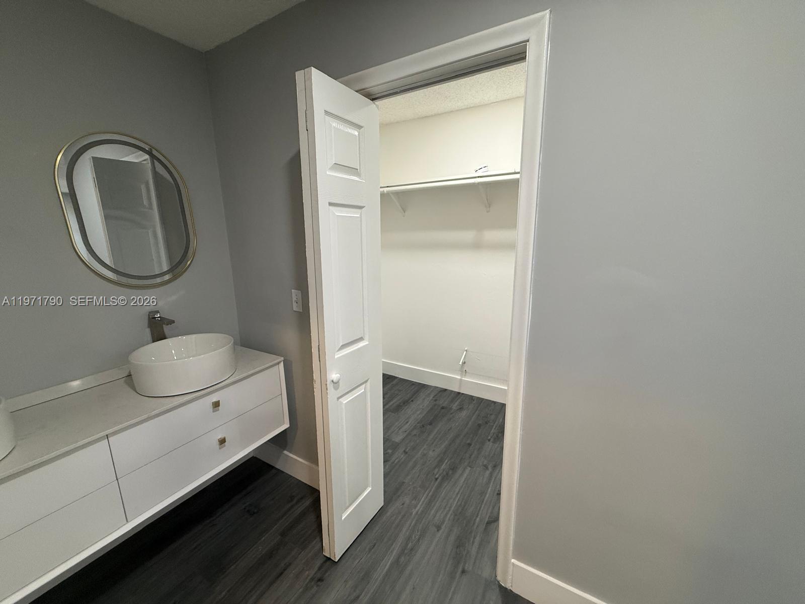 2700 North 34th Avenue, Unit I Hollywood, FL 33021 - Photo 25 of 35 a bathroom with a toilet a sink and a mirror
