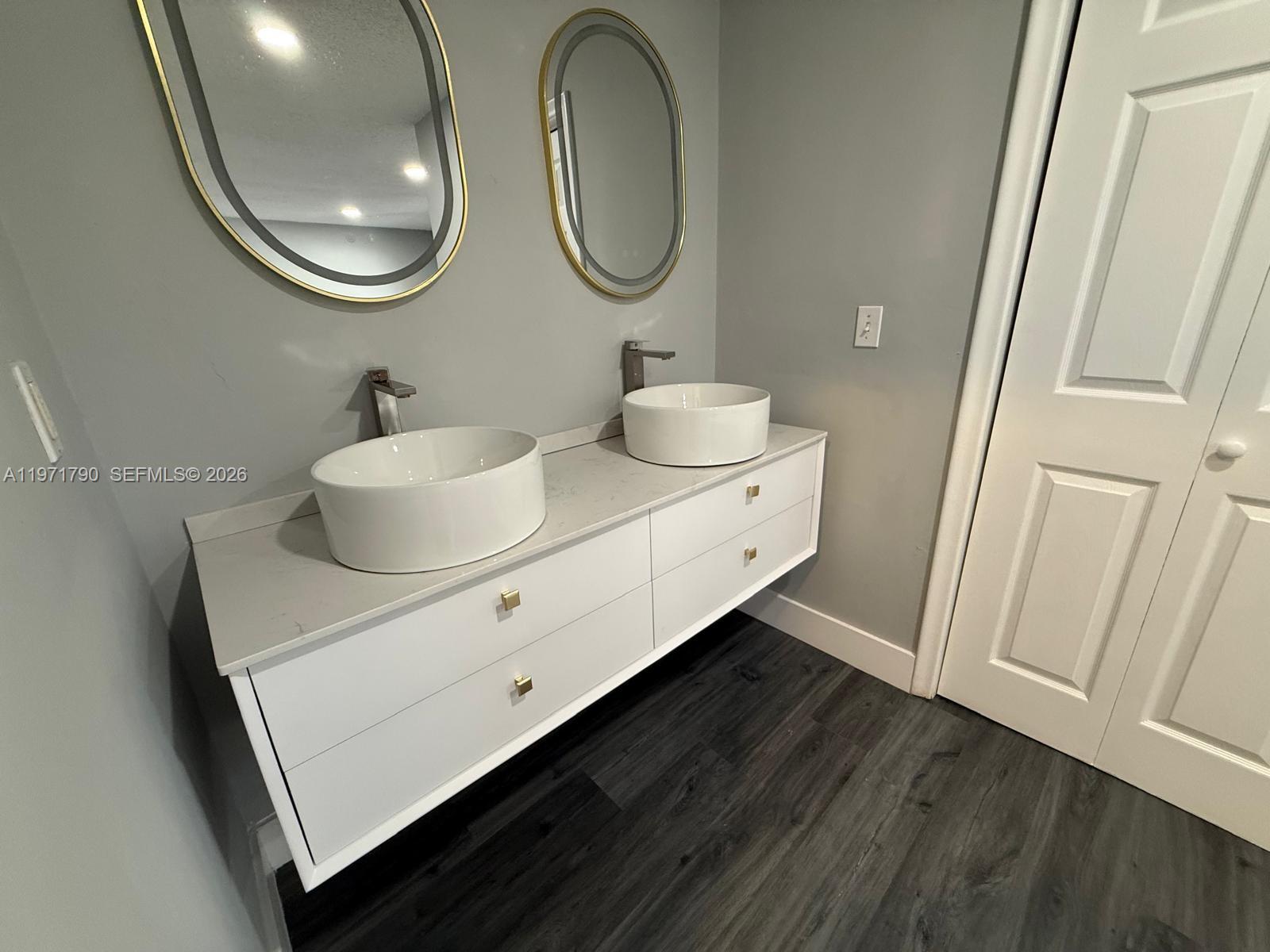 2700 North 34th Avenue, Unit I Hollywood, FL 33021 - Photo 26 of 35 a bathroom with a sink and a mirror