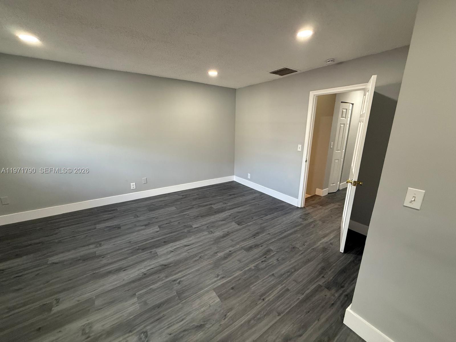 2700 North 34th Avenue, Unit I Hollywood, FL 33021 - Photo 28 of 35 an empty room with wooden floor and entrance