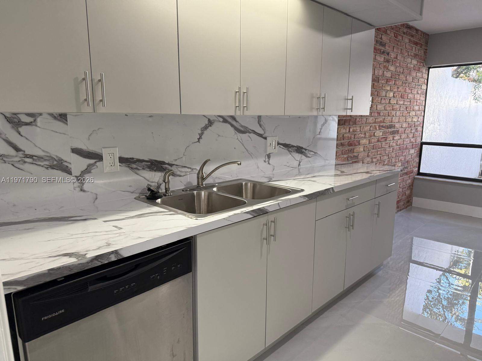 2700 North 34th Avenue, Unit I Hollywood, FL 33021 - Photo 29 of 35 a kitchen with a sink and cabinets