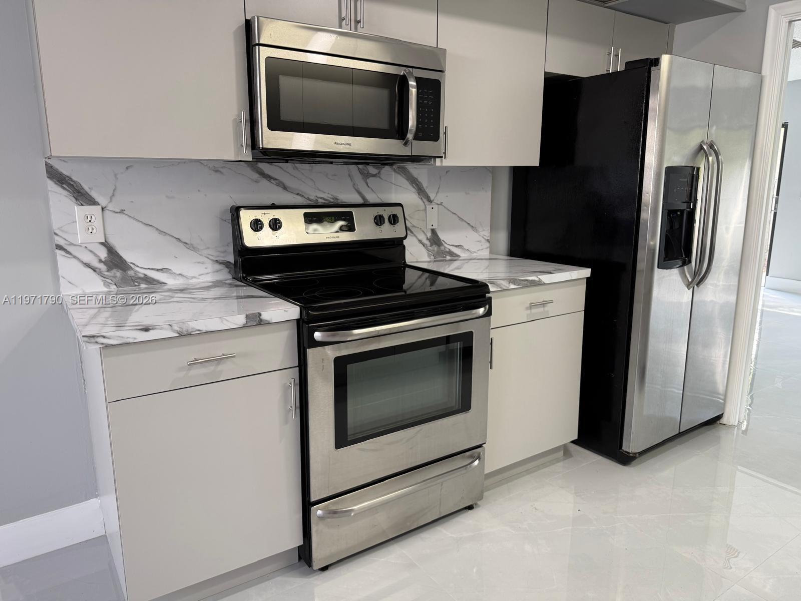 2700 North 34th Avenue, Unit I Hollywood, FL 33021 - Photo 30 of 35 a kitchen with a stove microwave and refrigerator