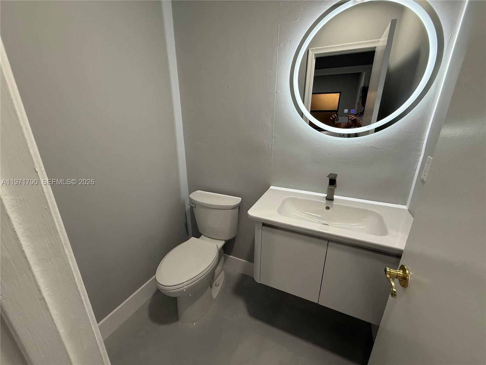 2700 North 34th Avenue, Unit I Hollywood, FL 33021 - Photo 33 of 35 a white toilet sitting next to a sink and a sink