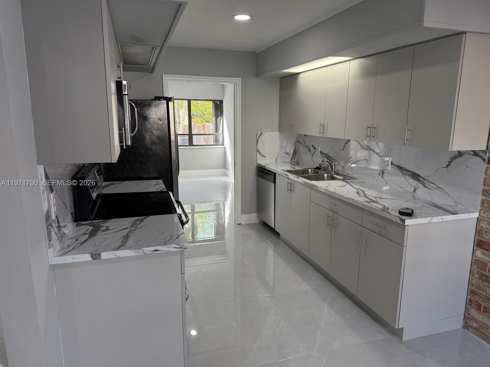 2700 North 34th Avenue, Unit I Hollywood, FL 33021 - Photo 4 of 35 a kitchen with a sink and a stove top oven