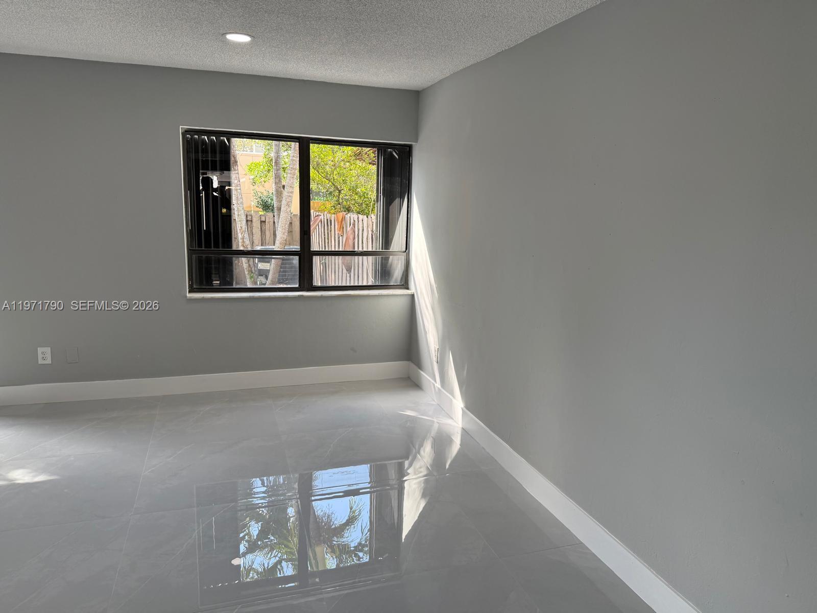 2700 North 34th Avenue, Unit I Hollywood, FL 33021 - Photo 8 of 35 a view of an empty room with a window