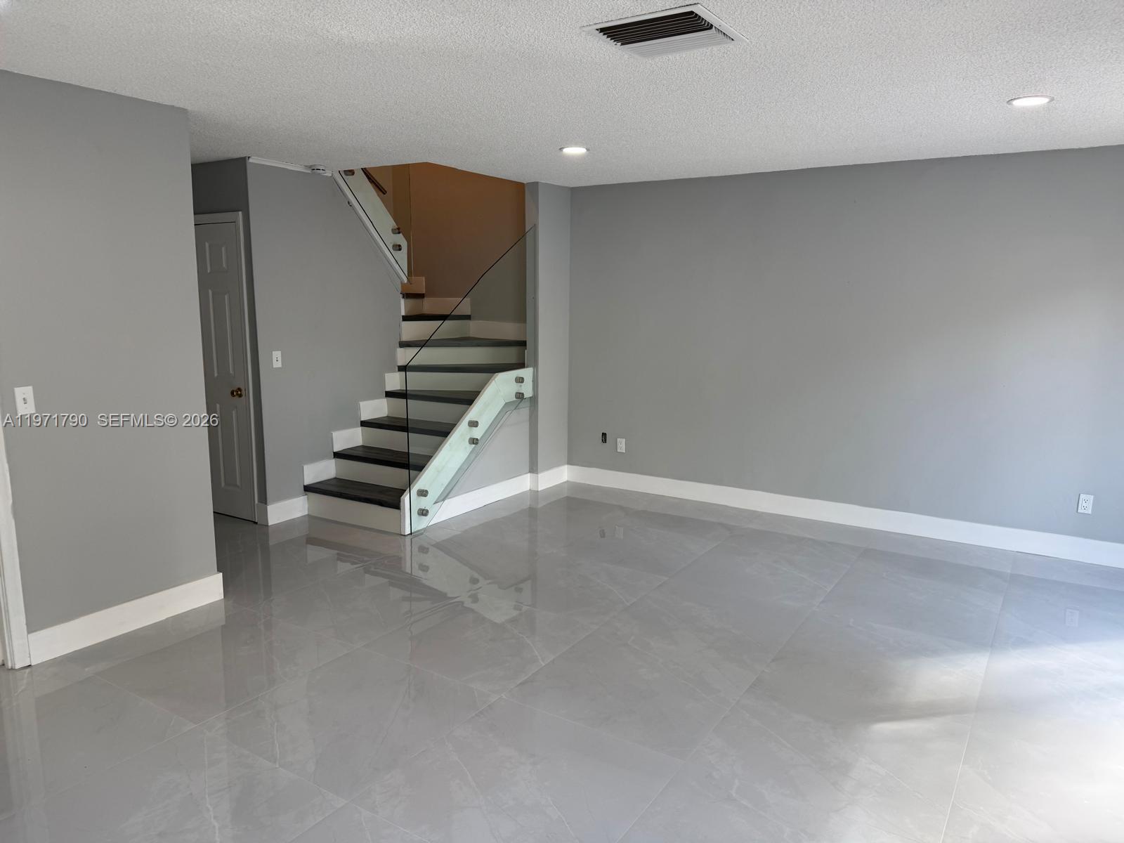 2700 North 34th Avenue, Unit I Hollywood, FL 33021 - Photo 10 of 35 an empty room with windows and stairs
