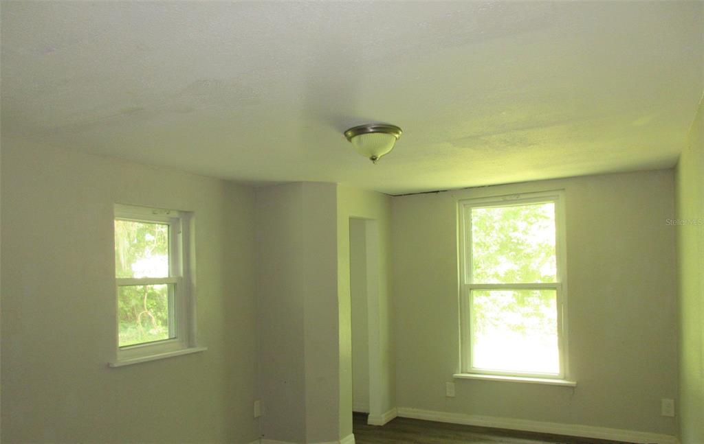 214 West Dade Avenue Bushnell, FL 33513 - Photo 7 of 13 a view of a windows and chandelier fan in a room