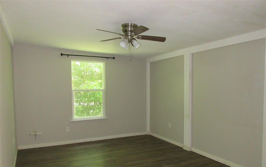 214 West Dade Avenue Bushnell, FL 33513 - Photo 9 of 13 a view of a livingroom with a ceiling fan and window