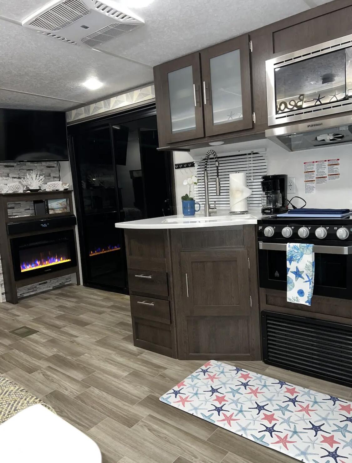 325 Calusa Street, Unit 478 Key Largo, FL 33037 - Photo 36 of 38 a kitchen with stainless steel appliances kitchen island granite countertop a stove and cabinets