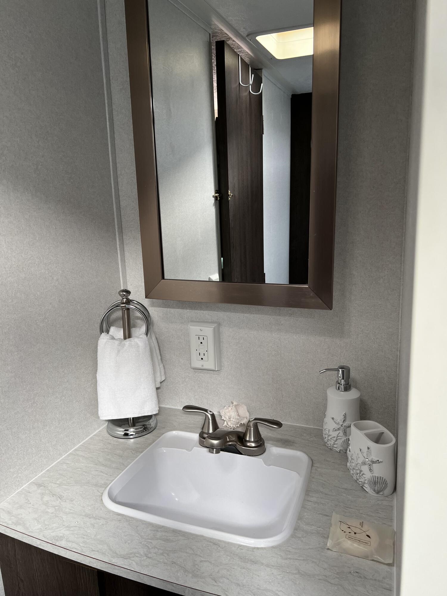 325 Calusa Street, Unit 478 Key Largo, FL 33037 - Photo 6 of 38 a bathroom with sink and mirror