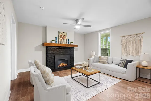 a living room with furniture and a fireplace