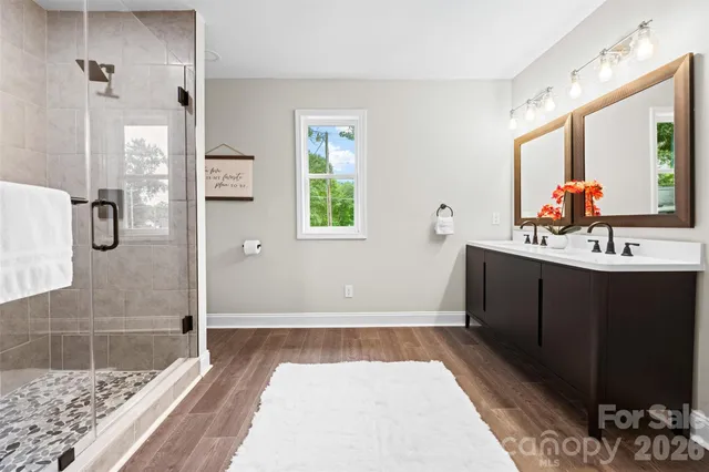a bathroom with a sink a mirror and a shower