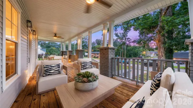 a view of a porch with furniture and wooden floor