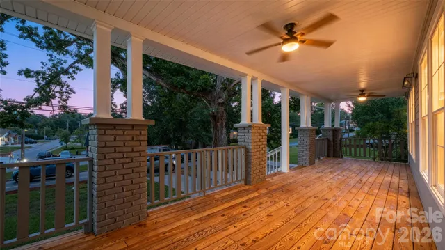 a view of a porch with wooden floor and fence