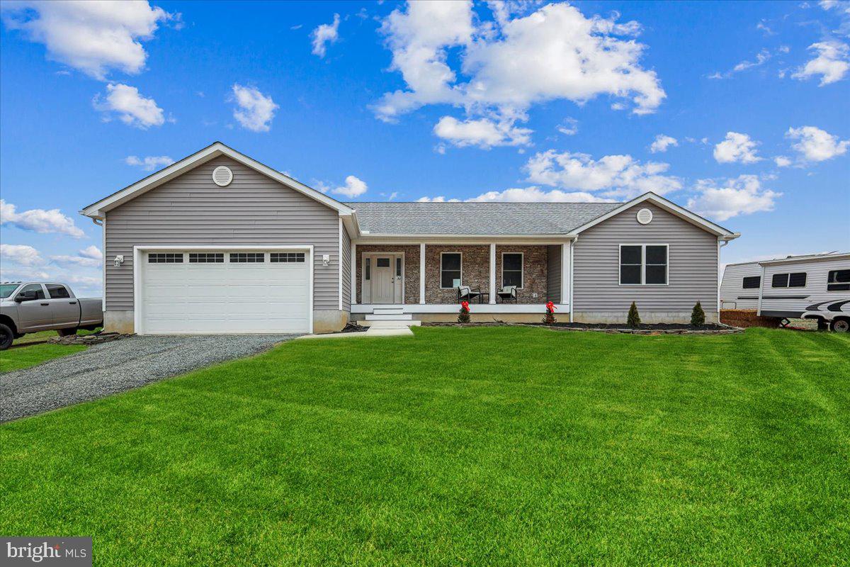 a front view of a house with a garden and yard