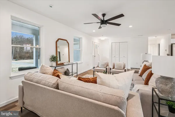 a living room with furniture kitchen view and a dining table