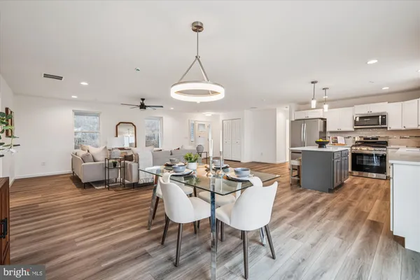 a view of kitchen and dining room with wooden floor