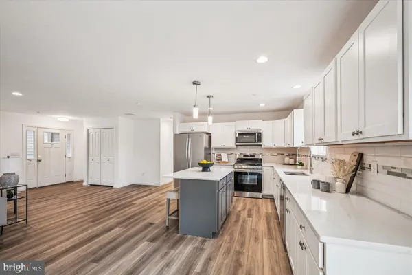 a kitchen with stainless steel appliances granite countertop a sink and a stove