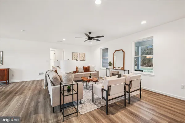 a living room with furniture and a kitchen view