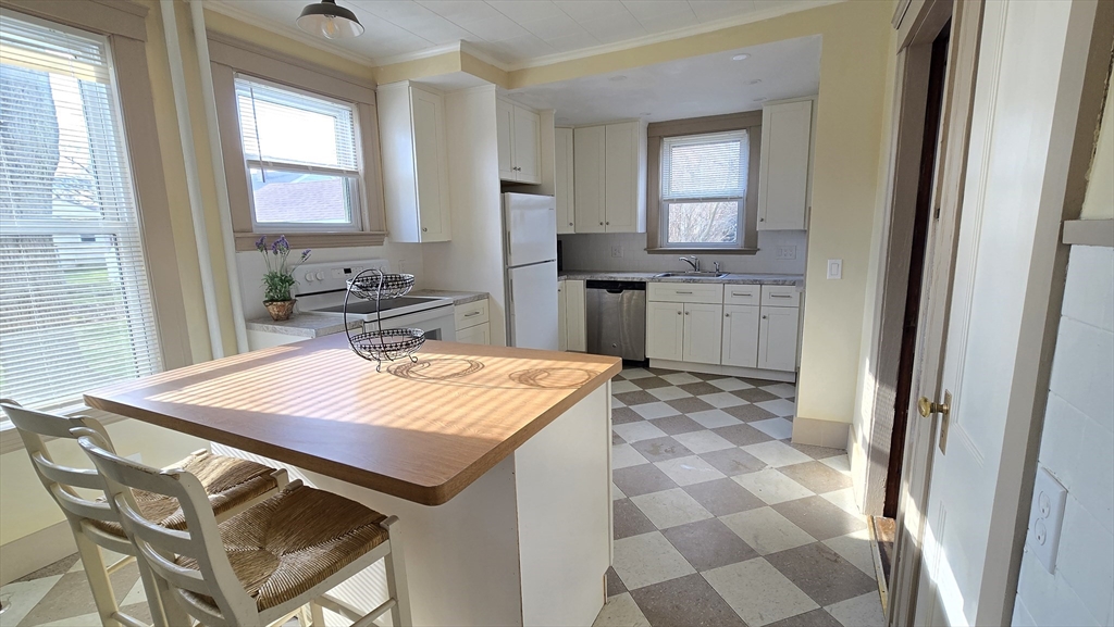 336 Burncoat Street Worcester, MA 01606 - Photo 11 of 40 a kitchen with a stove a sink and a refrigerator